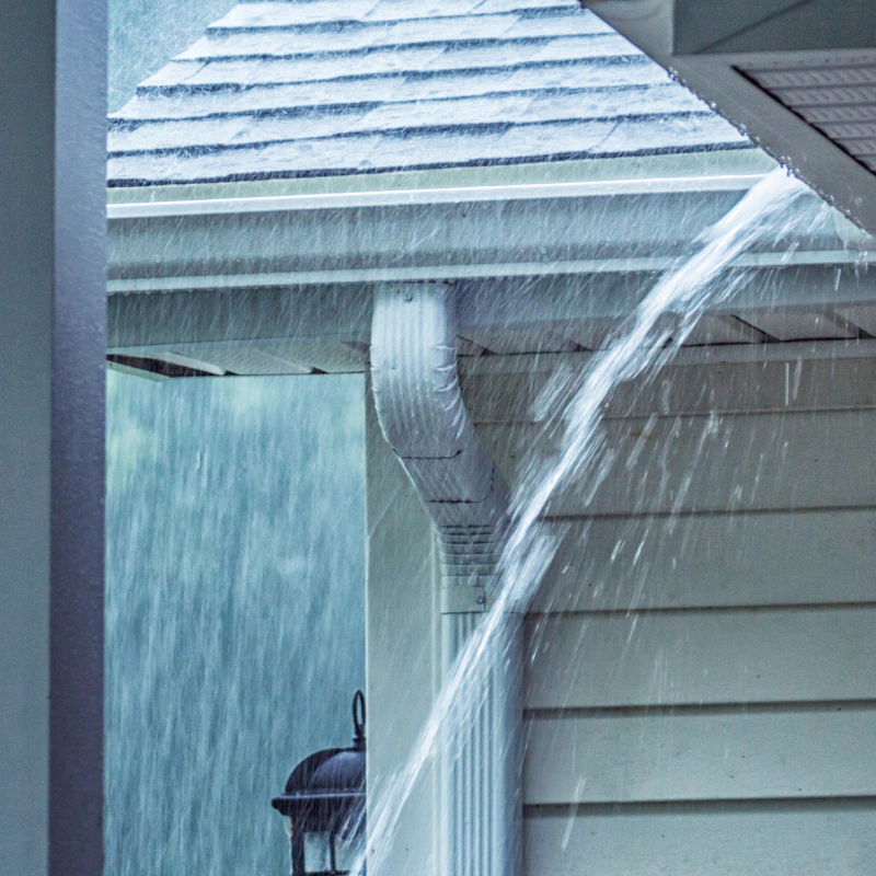 rain water pouring hard on roof and house roof gutter